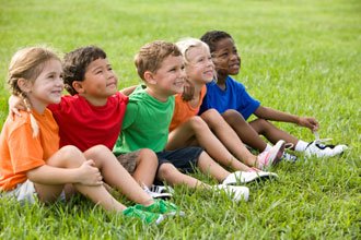 image of children sitting in the grass